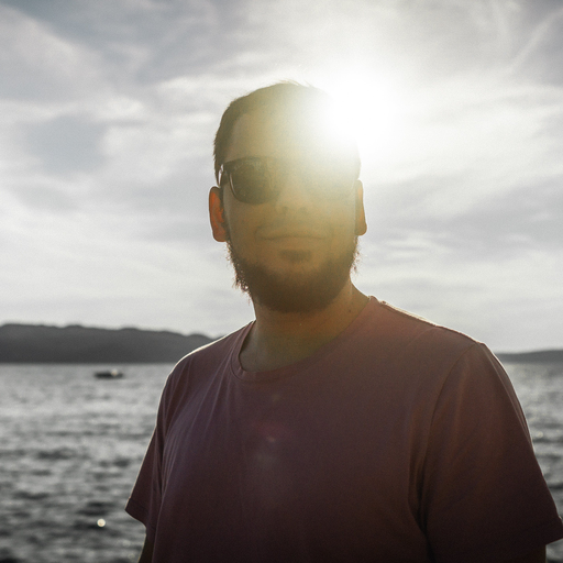 Tomas Votava, profile picture, staring mysteriously into the lense, Sun in the background